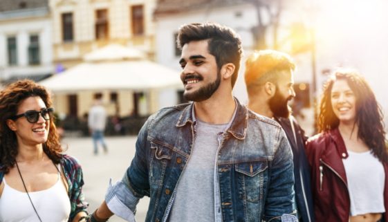 Man who overcame anxiety thanks to CBD walking downtown with his friends