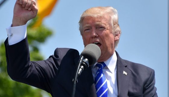 President Trump speaking in a microphone