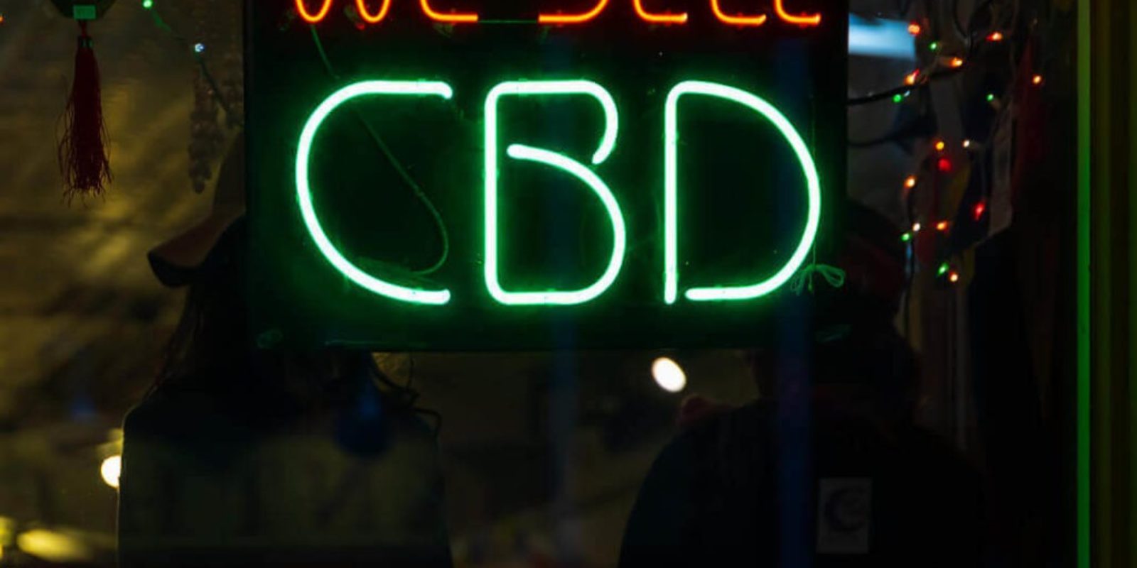 "We sell CBD" neon sign in the window of a CBD Franchise
