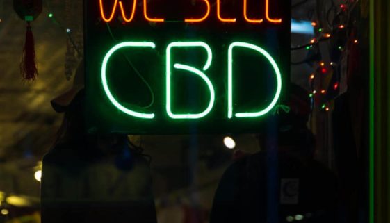 "We sell CBD" neon sign in the window of a CBD Franchise